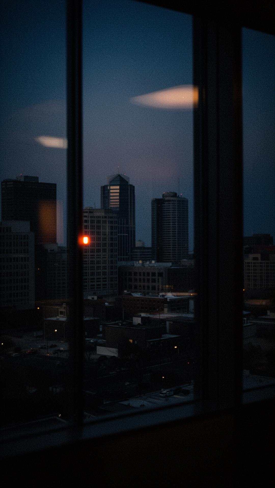 Raleigh, North Carolina skyline at dusk seen through an office window